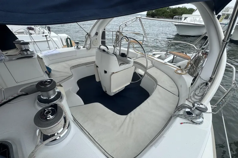Slide: The Image of Cockpit of 1998 Hunter 410 sailboat with steering wheel and seating area. - 23