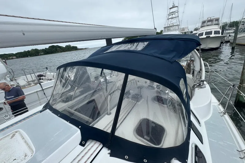 Slide: The Image of Sailboat Hunter 410, 1998 model, docked with blue canopy and clear windows. - 25