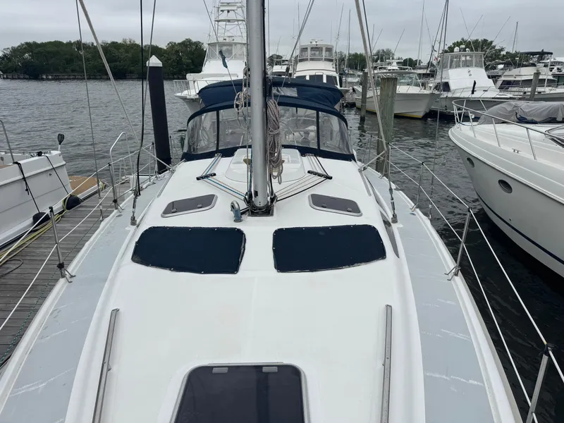 Slide: The Image of Sailboat docked at marina, Hunter 410 model, 1998, with blue covers and clear sky. - 26
