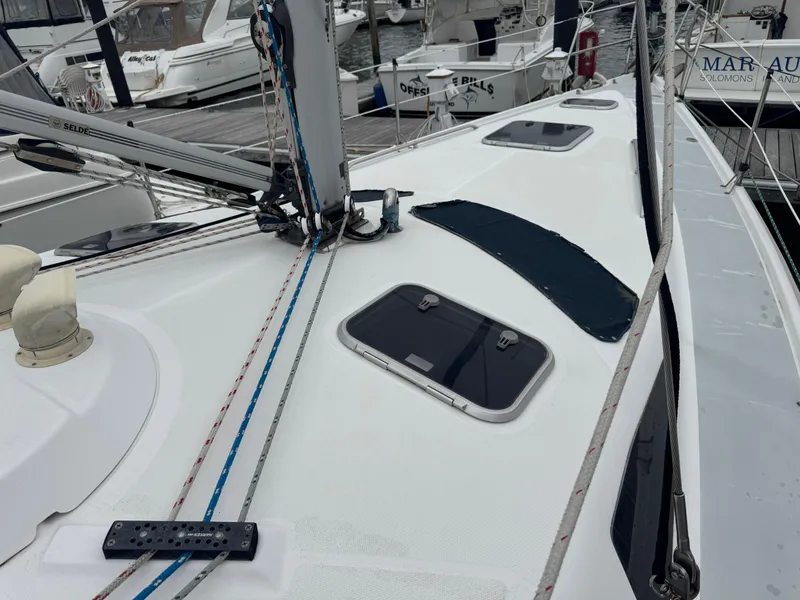 Slide: The Image of Sailboat deck of 1998 Hunter 410, featuring hatches and rigging in a marina setting. - 28