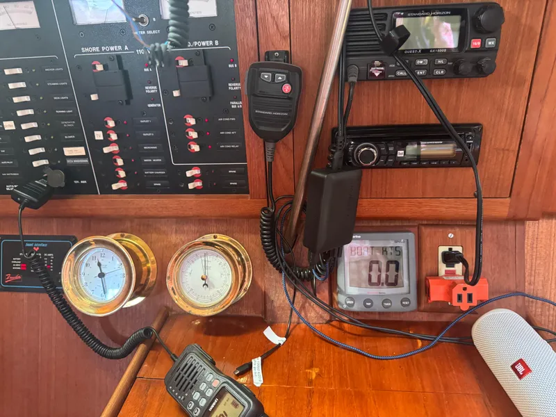 Slide: The Image of Control panel of a 1998 Hunter 410 boat with gauges and communication devices. - 3