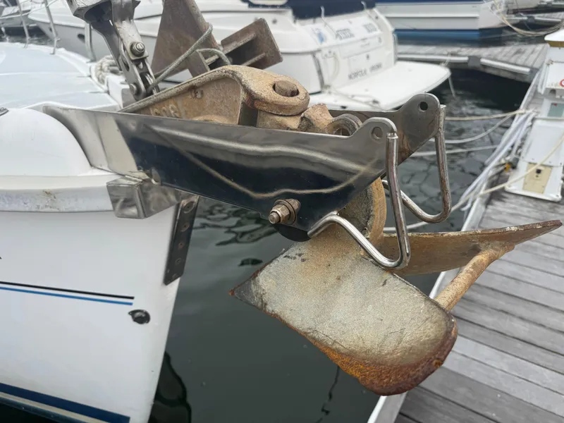 Slide: The Image of Anchor on a 1998 Hunter 410 sailboat docked at a marina. - 34