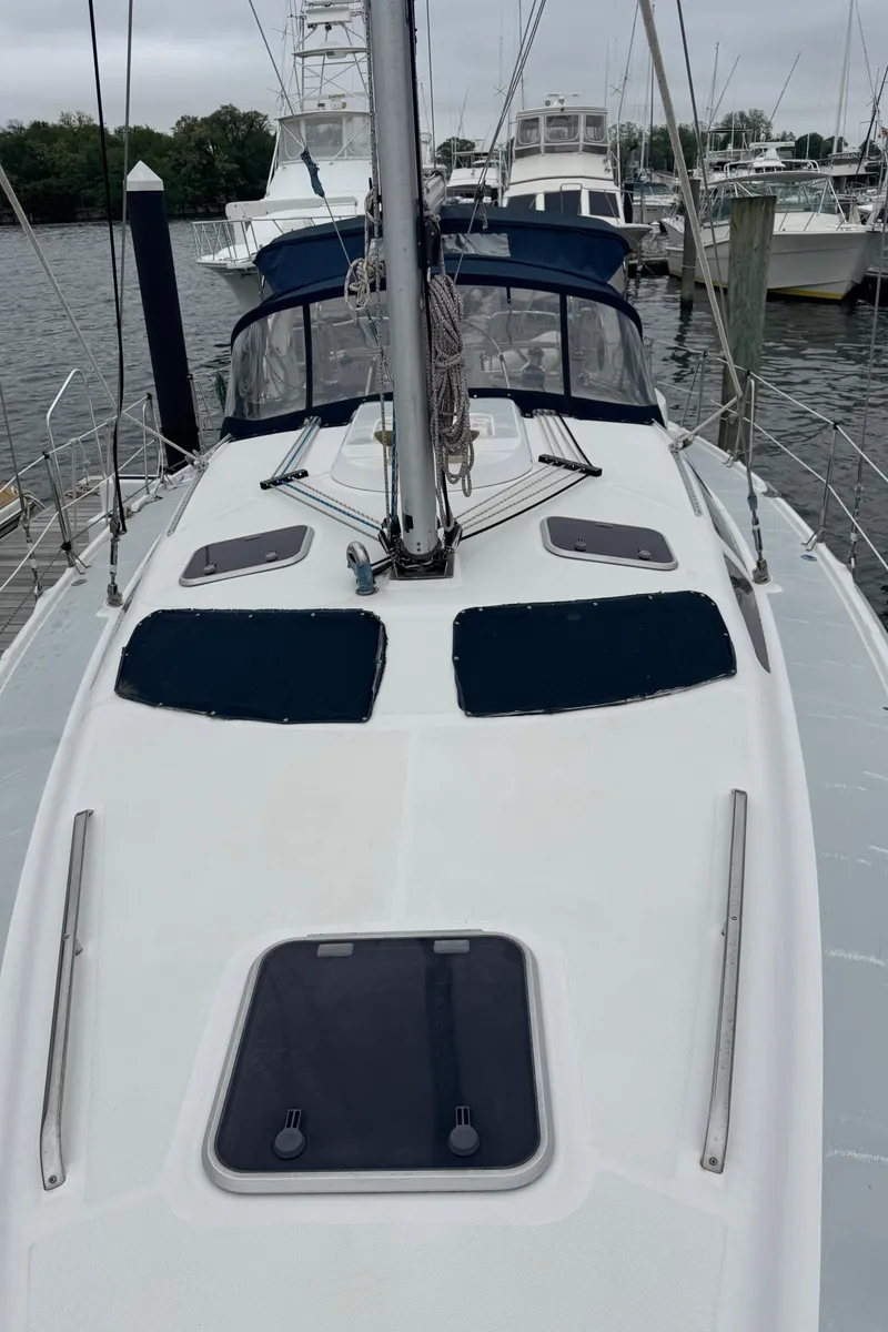 Slide: The Image of 1998 Hunter 410 sailboat docked, featuring a sleek deck and modern design. - 35