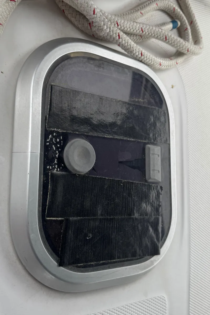 Slide: The Image of Oval hatch on 1998 Hunter 410 sailboat with rope detail. - 39