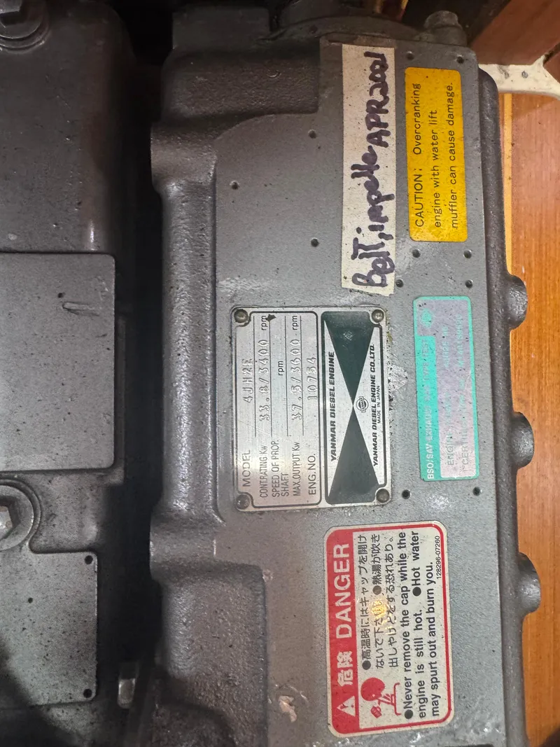 Slide: The Image of Close-up of a 1998 Hunter 410 engine with warning labels and handwritten notes. - 40