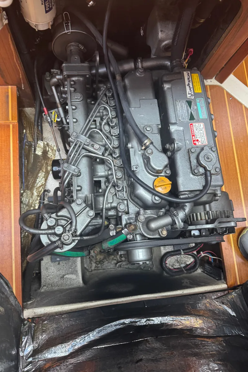 Slide: The Image of Engine compartment of a 1998 Hunter 410 sailboat, showcasing detailed mechanical components. - 5