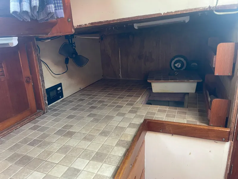 Slide: The Image of 1976 Cheoy Lee Clipper 42 interior with tiled countertop and wooden cabinetry. - 21