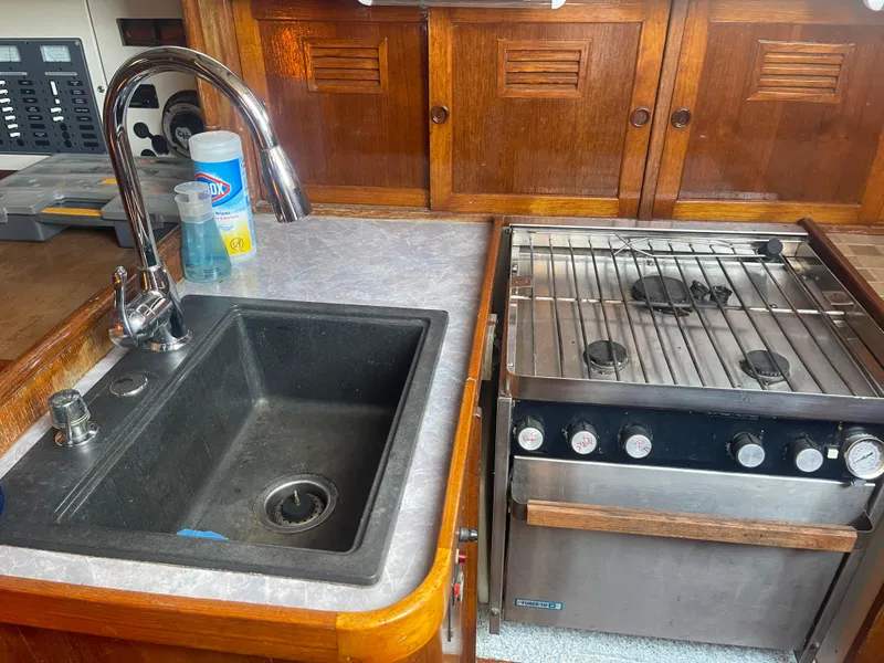 Slide: The Image of 1976 Cheoy Lee Clipper 42 yacht kitchen with sink and stove. - 22