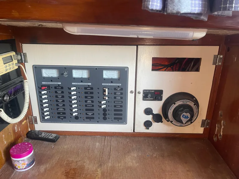 Slide: The Image of Electrical panel inside a 1976 Cheoy Lee Clipper 42 yacht, featuring gauges and switches. - 23