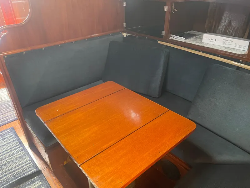 Slide: The Image of 1976 Cheoy Lee Clipper 42 interior with wooden table and cushioned seating. - 29