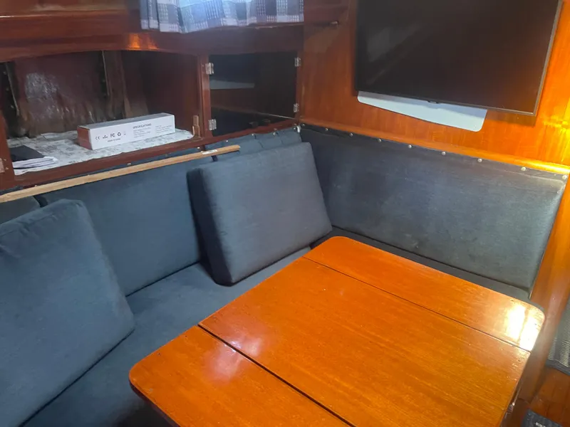 Slide: The Image of 1976 Cheoy Lee Clipper 42 interior with wooden table and cushioned seating. - 30