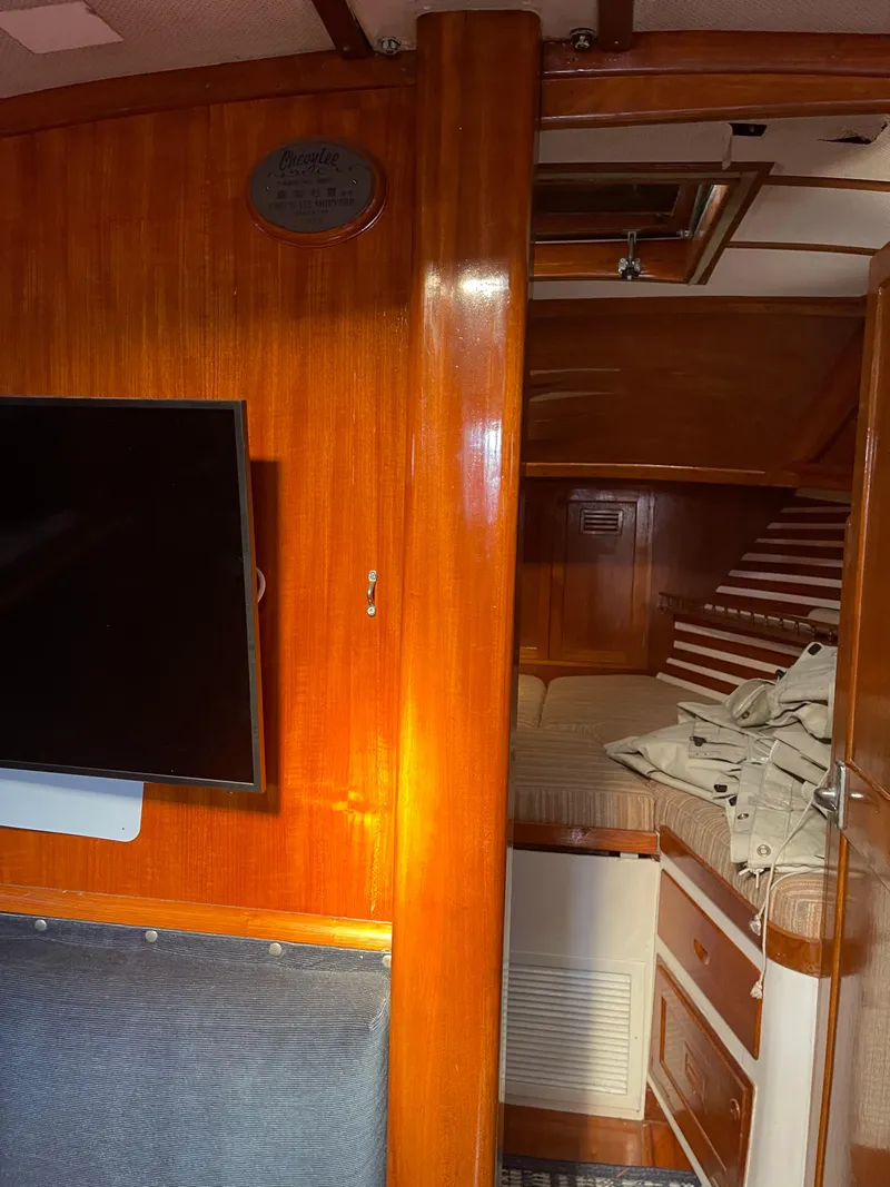 Slide: The Image of 1976 Cheoy Lee Clipper 42 interior with wood paneling and cozy cabin space. - 32