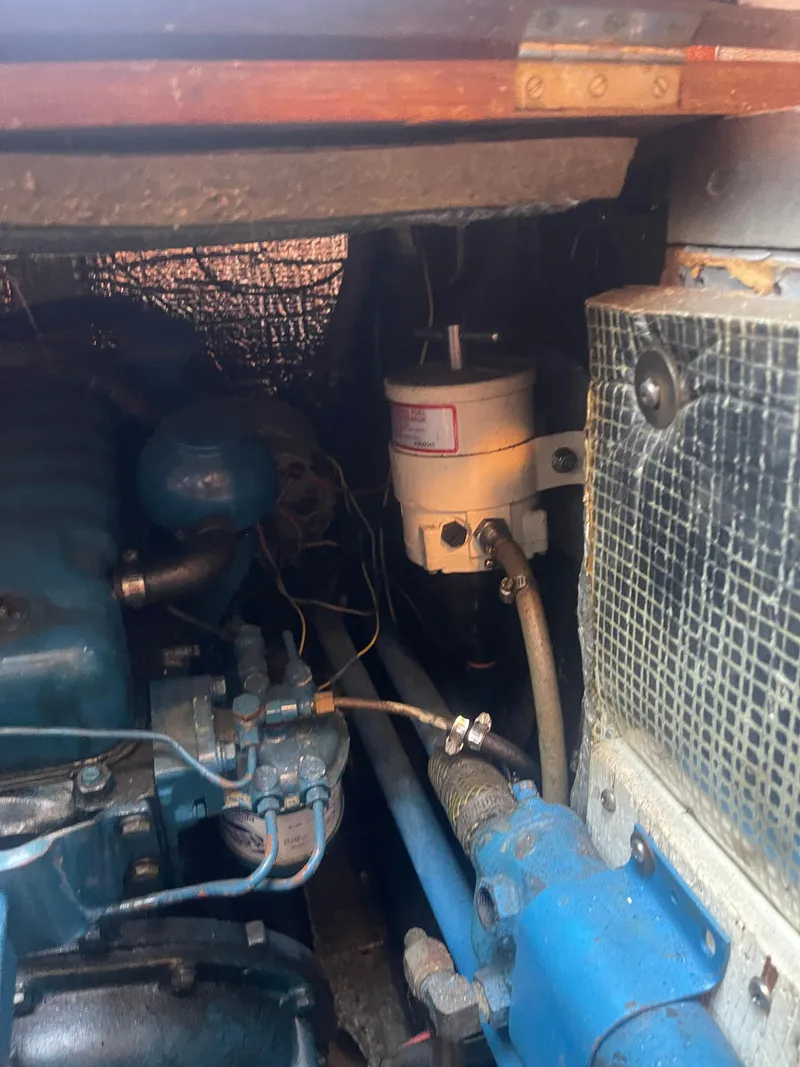Slide: The Image of Engine compartment of a 1976 Cheoy Lee Clipper 42, showcasing mechanical components and wiring. - 38