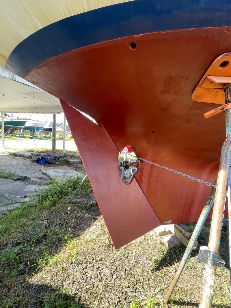 Slide: The Image of 1976 Cheoy Lee Clipper 42 sailboat hull under maintenance, showcasing rudder and propeller. - 5