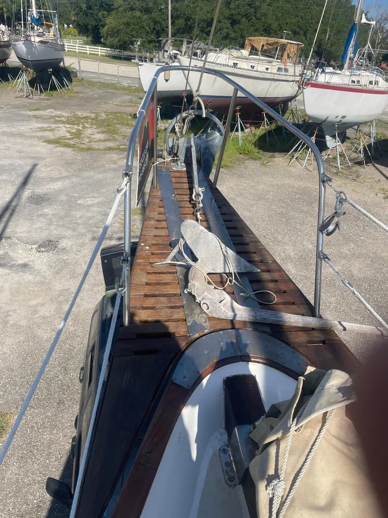 Slide: The Image of 1976 Cheoy Lee Clipper 42 sailboat deck with anchor, docked on land. - 6