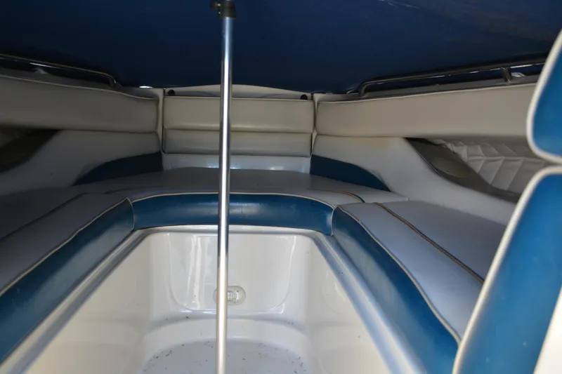 Slide: The Image of Interior view of a 1997 Maxum 2300 SR boat with blue and white seating. - 11