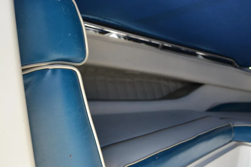 Slide: The Image of Interior seating of a 1997 Maxum 2300 SR boat with blue and white upholstery. - 12