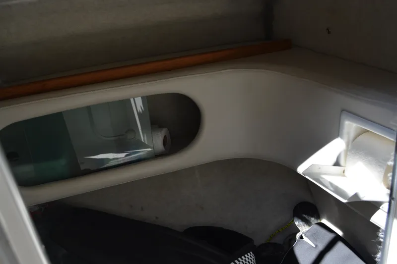 Slide: The Image of Interior view of a 1997 Maxum 2300 SR boat, featuring storage compartments. - 15