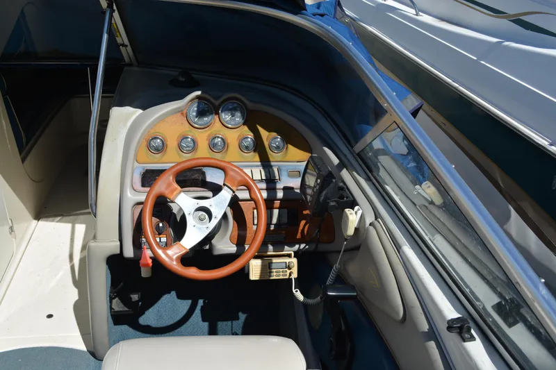Slide: The Image of 1997 Maxum 2300 SR boat dashboard with wooden steering wheel and instrument panel. - 7
