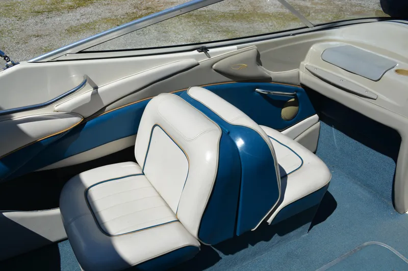 Slide: The Image of Interior of a 1997 Maxum 2300 SR boat with blue and white seating. - 9