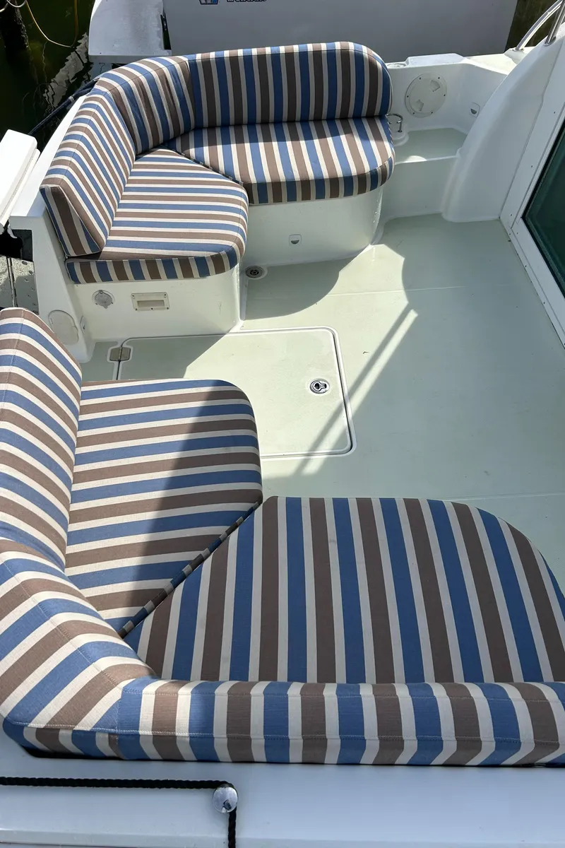Slide: The Image of 2018 Back Cove 32 boat with striped seating on deck. - 5