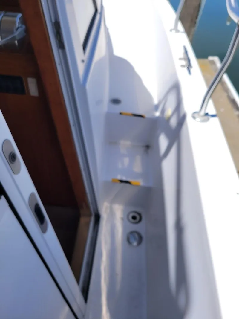 Slide: The Image of 1999 Mainship 430 Trawler deck view with open door and railing. - 16