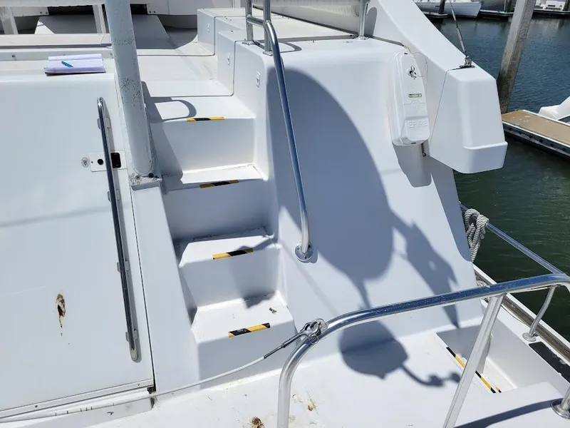 Slide: The Image of Staircase on 1999 Mainship 430 Trawler, leading to upper deck, with safety railings. - 27