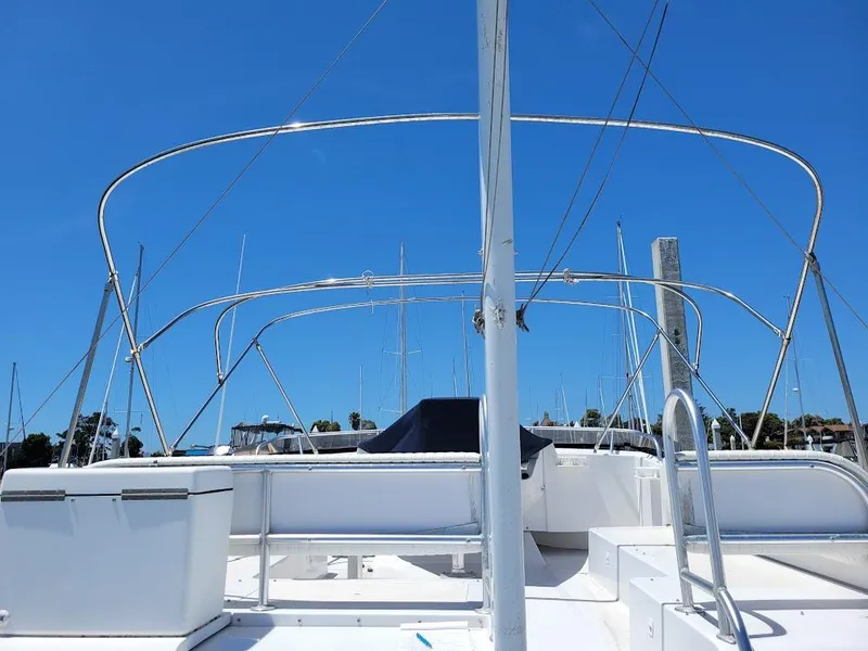 Slide: The Image of 1999 Mainship 430 Trawler deck with railings under clear blue sky. - 28