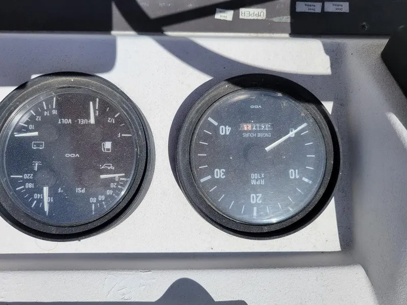 Slide: The Image of Instrument panel of a 1999 Mainship 430 Trawler showing gauges and dials. - 33