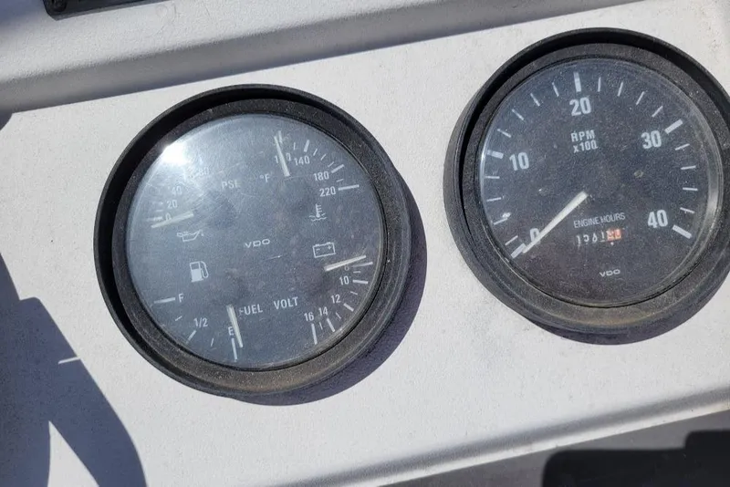 Slide: The Image of Instrument panel of a 1999 Mainship 430 Trawler, showing fuel and RPM gauges. - 34