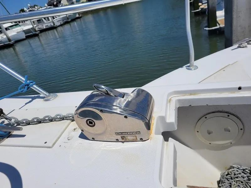 Slide: The Image of 1999 Mainship 430 Trawler deck with anchor winch, docked at marina. - 4