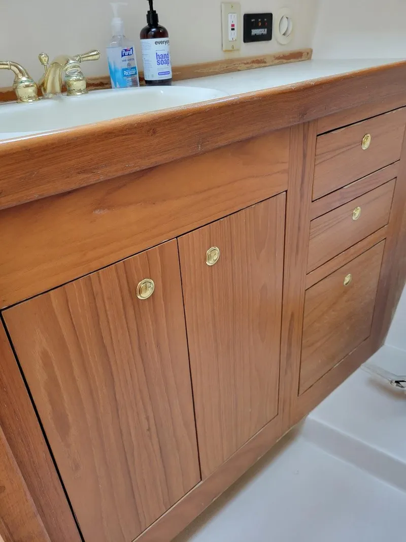 Slide: The Image of Wooden cabinet with brass handles in 1999 Mainship 430 Trawler bathroom. - 42