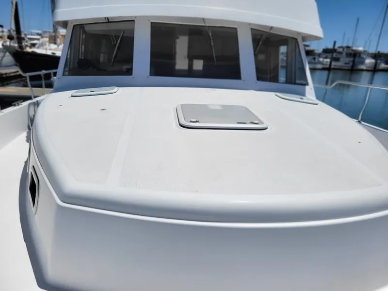 Slide: The Image of 1999 Mainship 430 Trawler boat deck with hatch, docked in marina. - 6