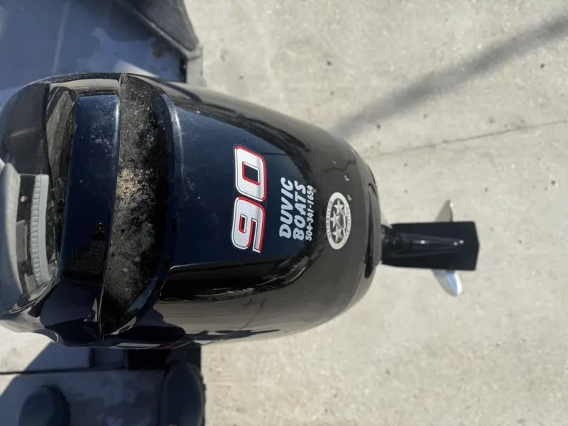 Slide: The Image of Outboard motor with "90" label on a War Eagle 18 boat, 2000 model. - 11