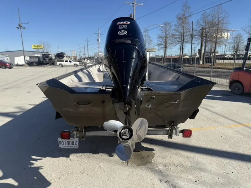Slide: The Image of Rear view of a 2000 War Eagle 18 boat with an outboard motor. - 3