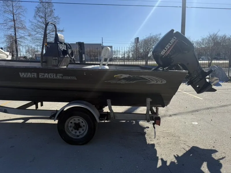 Slide: The Image of 2000 War Eagle 18 boat with Suzuki outboard motor on trailer. - 5