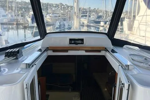 Slide: The Image of 2006 Hunter 44 Deck Salon yacht interior with marina view through windows. - 10