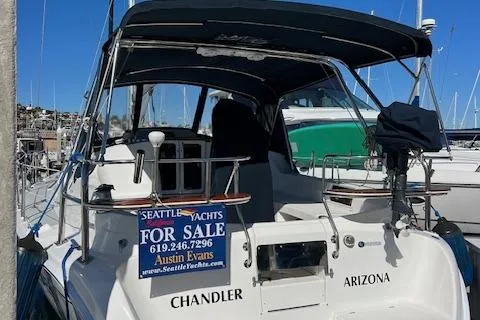 Slide: The Image of 2006 Hunter 44 Deck Salon yacht for sale, docked with canopy and signage. - 13