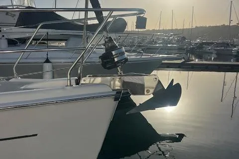 Slide: The Image of 2006 Hunter 44 Deck Salon yacht anchored in a marina at sunset. - 14