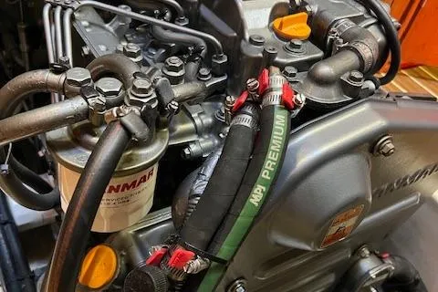 Slide: The Image of Engine components of a 2006 Hunter 44 Deck Salon yacht, featuring Yanmar parts and hoses. - 15