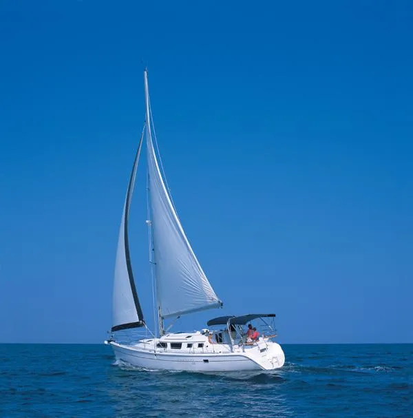 Slide: The Image of 2006 Hunter 44 Deck Salon sailing on open sea under clear blue sky. - 24