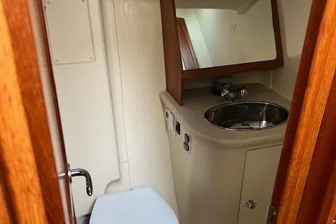 Slide: The Image of 2006 Hunter 44 Deck Salon bathroom with sink, mirror, and toilet. - 28