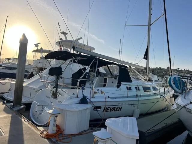Slide: The Image of 2006 Hunter 44 Deck Salon sailboat docked at marina during sunset. - 3
