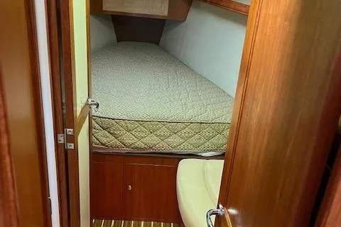 Slide: The Image of Cozy cabin interior of 2006 Hunter 44 Deck Salon sailboat with wooden finish. - 31
