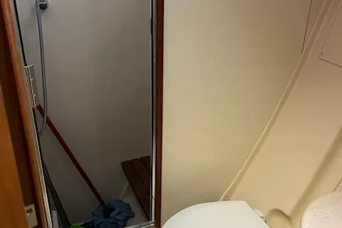Slide: The Image of Bathroom interior of 2006 Hunter 44 Deck Salon yacht, featuring shower and toilet. - 33