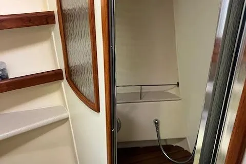 Slide: The Image of 2006 Hunter 44 Deck Salon yacht interior with shower and wooden accents. - 35
