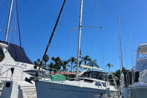 Slide: The Image of 2006 Hunter 44 Deck Salon sailboat docked under clear blue sky. - 4