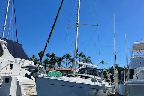 Slide: The Image of 2006 Hunter 44 Deck Salon sailboat docked under clear blue sky. - 5