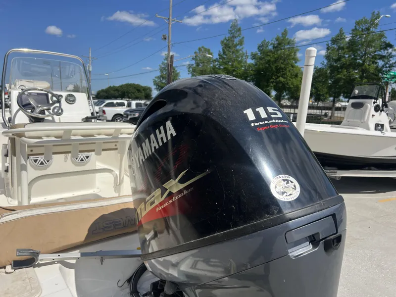 Slide: The Image of 2018 Key West 176 Island Bay boat with Yamaha 115 outboard motor in a sunny marina. - 10