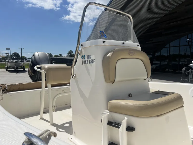 Slide: The Image of 2018 Key West 176 Island Bay boat interior with seating and console under sunny sky. - 7
